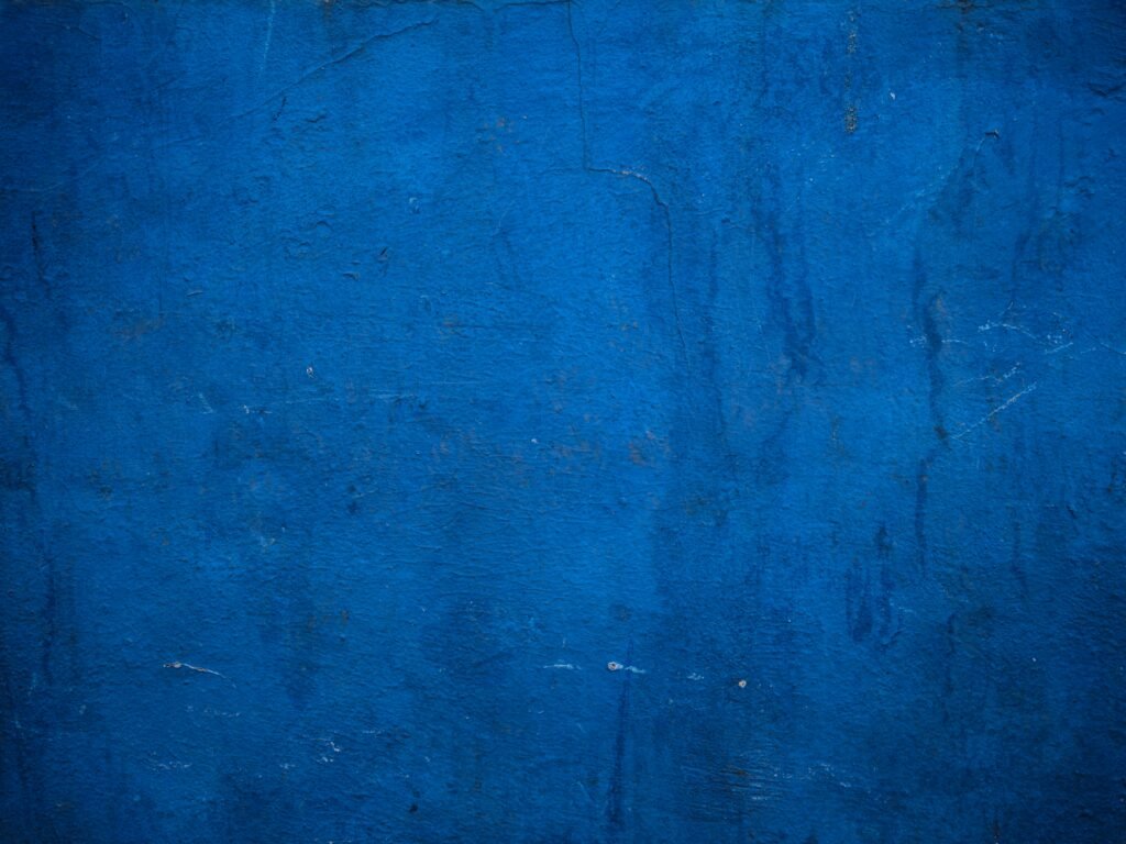 A vibrant blue wall with a textured surface, perfect for backgrounds and design use.